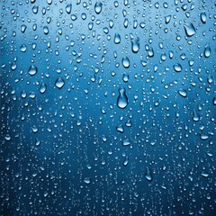 Water droplets on a blue background, creating a fresh and tranquil atmosphere.