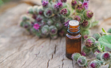 Burdock extract in a bottle. Selective focus.