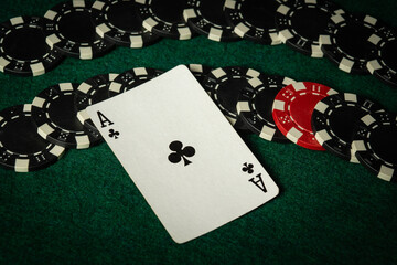 Ace of clubs on game chips as a bad forecast in poker. Concept of losing in the club on the green table