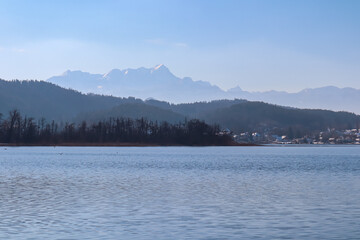 Panoramic view of alpine Lake W&ouml;rth surrounded by majestic mountains of Karawanks in Carinthia, Austria, Europe. Crystal-clear waters shimmer in sunlight. Viewing platform Hohe Gloriette, P&ouml;rtschach