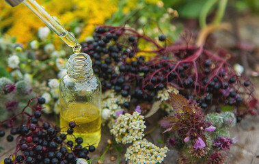 Flower and herbal extract in a bottle. Selective focus.