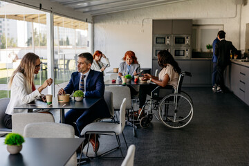 Multiracial business people having lunch together in office cafeteria