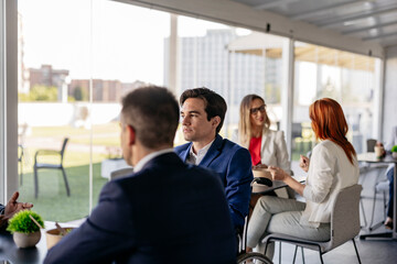 Business people having working lunch meeting in modern office restaurant