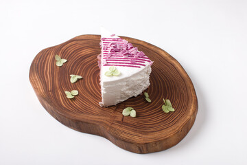 a piece of cake on a wooden serving board. Airy confection