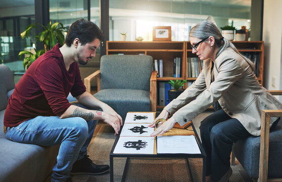 Therapy, psychologist and man with rorschach test for personality assessment, help or support. Therapist, inkblot or patient in consultation for mental health exam, emotion or mind analysis in office