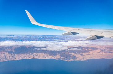 View from the airplane window of the mountains and sea resort with corals in Egypt, Sharm El Sheikh.Flight