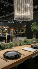 A stylish dining arrangement showcases black plates and elegant glassware surrounded by lush greenery and softly flickering candles, highlighting modern design elements