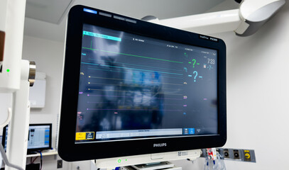 hospital monitors displaying vital signs, including heart rate, oxygen levels, and blood pressure. Represents the precision and urgency of medical care, life monitoring, and patient well-being