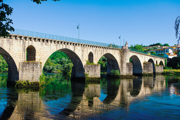 Fototapeta premium Stone bridge over the Lima river in Ponte da Barca. Portugal