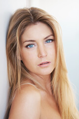 Naklejka premium Aesthetic, portrait and skincare with woman in studio for dermatology, natural cosmetics or wellness. Beauty, blue eyes and face of confident model on white background for collagen or cosmetology