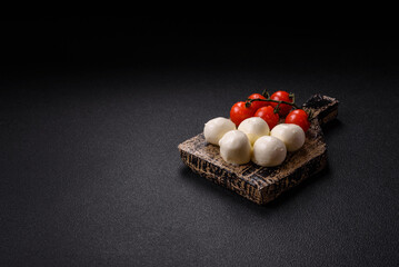 Delicious fresh mozzarella cheese with tomatoes, salt and spices