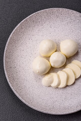 Delicious fresh mozzarella cheese with tomatoes, salt and spices