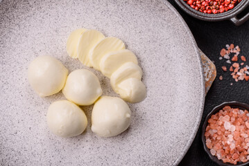 Delicious fresh mozzarella cheese with tomatoes, salt and spices