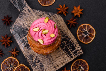 Sweet craffin or panettone garnished with raspberry and pistachio flavored cream