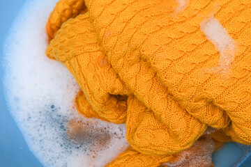Hand washing of delicate woolen knitted clothes, sweaters concept