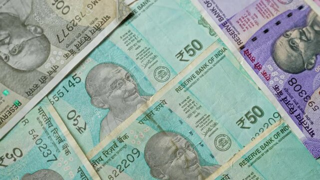 Indian currency banknotes including 50 rupees, 100 rupees, 500 rupees, and 2000 rupees, featuring prominent mahatma gandhi portrait, displayed in a layered arrangement.