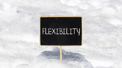 Flexibility symbol. Concept word Flexibility on beautiful chalk blackboard. Beautiful white snow...