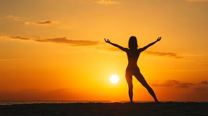 Young woman practicing yoga on a beach at sunset, silhouette against orange sky.