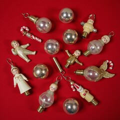 A vintage Christmas scene featuring red-hued ornaments and baubles from the 1950s on a festive background