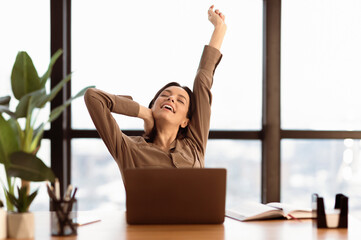 Stiff Neck Exercises. Happy freelancer stretching body working at home or modern office, copyspace