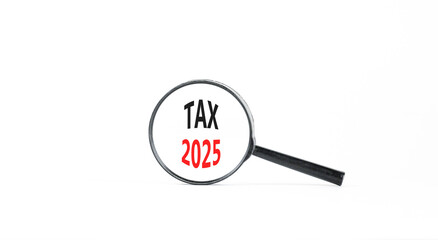 Planning tax 2025 new year symbol. Concept words Tax 2025 on beautiful white paper in magnifying glass. Beautiful white paper background. Business tax 2025 new year concept. Copy space.