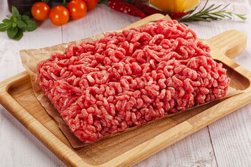 Raw minced beef meat over board