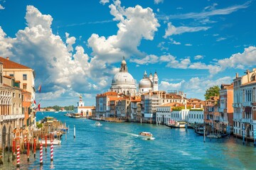 Naklejka premium The Grand Canal of Venice offers a picturesque afternoon view with colorful buildings lining the waterway and boats gently cruising under fluffy clouds.