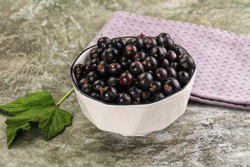 Ripe black currant in the bowl