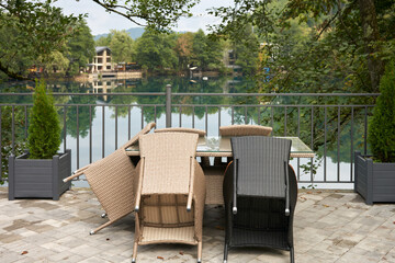 An early morning summer cafe on the shores of a karst lake with amazing water color in the mountains.