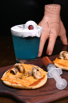 Naklejki halloween idea funny and horrifying dishes two mini pizza with skull on mushroom with sauce in syringe drink blue curaçao with eye