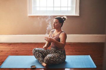 Woman, apartment and meditation with incense for peace, calm and mental health or mindfulness....