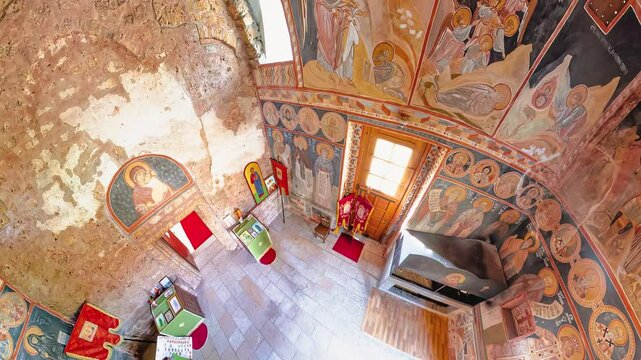 Sisevac, Serbia, Sept 3,2024: aerial view interior of the Sisojevac monastery church in Serbia with frescoes covering the walls and ceiling, illuminated by natural light from the windows