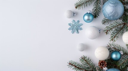 Obraz premium Blue and white Christmas ornaments, pine branches, snowflakes on a white background, minimalist holiday decor, festive arrangement, winter vibes, clear copyspace for text.