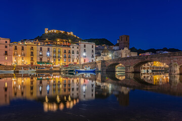 Beautiful view of the town of Bosa after sunset at blue hour, island of Sardinia, Italy.