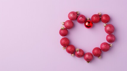 Heart-shaped Christmas ornament made with red baubles on a purple background, minimalist holiday design, festive decor, clear copyspace, joyful Christmas theme, vibrant composition.


