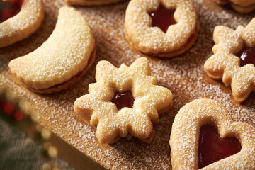 Homemade Linzer Christmas cookies filled with strawberry jam and dusted with sugar