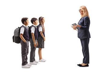 Full length shot of teacher talking to a group of schoolchildren