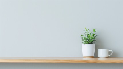 Minimalist Shelf with Potted Plant and Coffee Cup on Wooden Surface Against Light Gray Background, Copy Space for Text, Clean and Simple Interior Decor Scene

