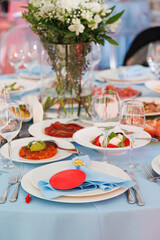Beautifully decorated catering banquet table with different food snacks and appetizers on corporate christmas birthday party event or wedding celebration