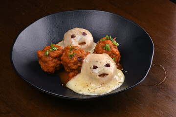 funny halloween starter meat dumplings in red sauce with cheese ghost close up fun