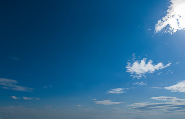 A clear blue sky with scattered clouds creates a serene atmosphere, perfect for backgrounds or...