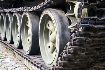 A caterpillar and road wheels of a historic Soviet tank from World War II in the city of Poznan