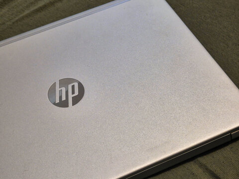 Warsaw, Poland - September 20, 2024: Close-up view of an HP laptop with a sleek silver design on a textured surface, showcasing modern technology and elegance.