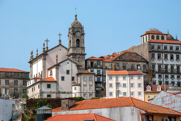 Fototapeta premium Cityscape of Porto, Portugal - with church in between houses