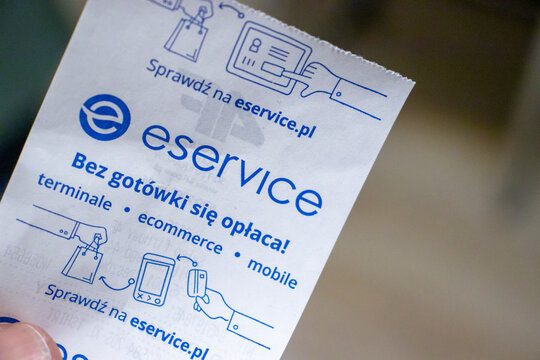 Rzeszow, Poland - September 20, 2024: A close-up of an eService promotional receipt, highlighting mobile payment solutions in Poland. Modern payment technology is showcased.
