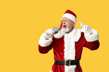 Santa Claus in glasses with microphone singing on yellow background