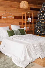 Interior of cozy bedroom with Christmas tree and presents