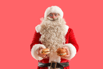 Santa Claus with tasty burgers on red background