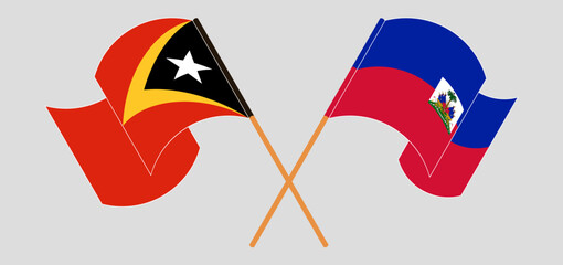 Crossed and waving flags of East Timor and Republic of Haiti. Vector illustration