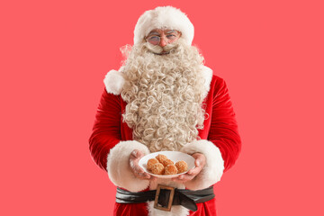 Santa Claus with tasty falafel balls on red background